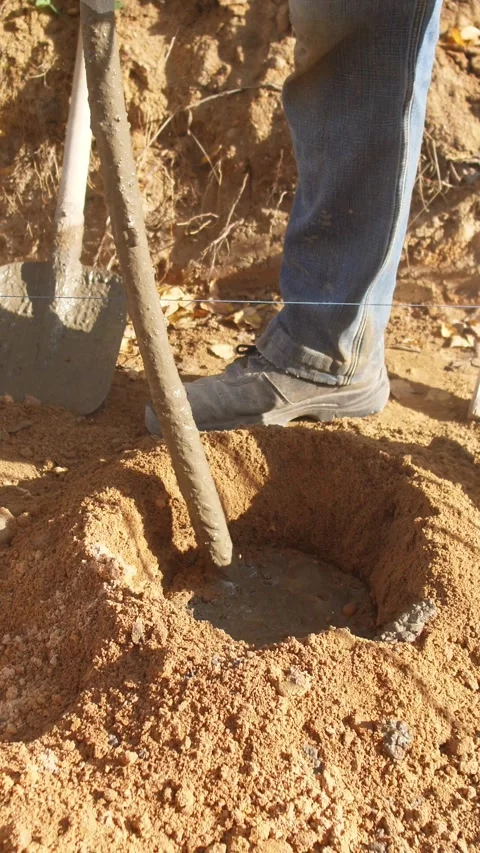 Drilling with auger, operator uses electric auger to drill holes, worker Stock Footage 319704608