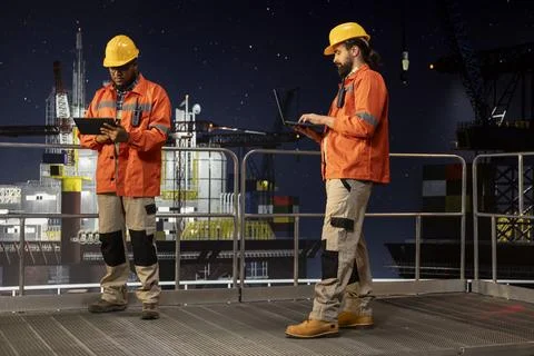 Drilling barge engineer managing operational workflows using tablet app Stock Photos