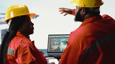 Drilling barge engineering team on deck studying geological maps Stock Footage 319971324