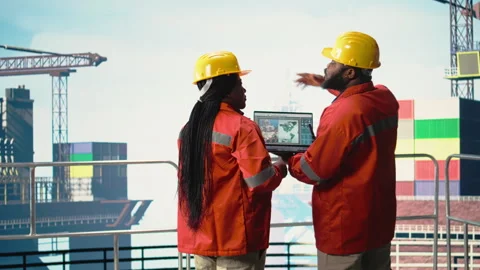 Drilling barge engineering team on deck studying geological maps Stock Footage 319975213