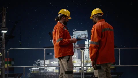 Drilling barge team using laptop to monitor malfunctions during oil crisis Stock Footage 336197921