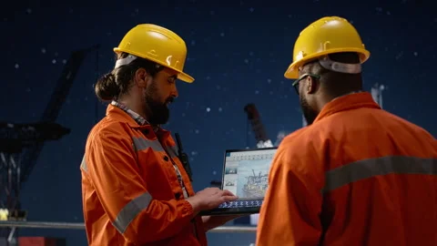 Drilling barge team using laptop to monitor malfunctions during oil crisis Stock Footage 336201211