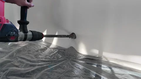 Drilling big hole in concrete wall with rotary hammer drill 库存影片 339079699