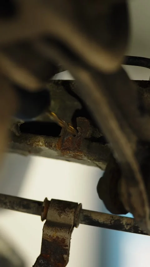 Drilling a broken bolt or hole in a rusty car suspension part Stock Footage 337890871