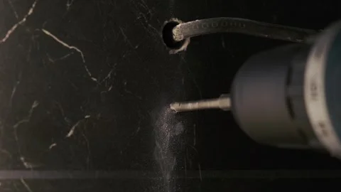 Drilling ceramic tile. Drill bit rotating in slow motion, professional drill Stock Footage 247136666