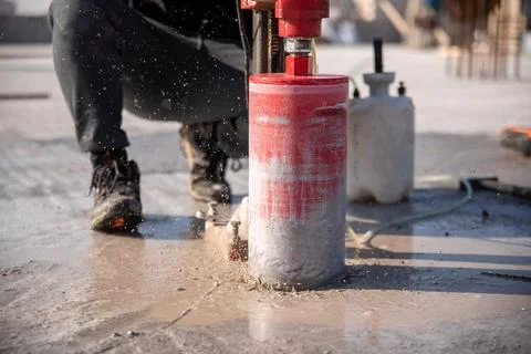 Drilling concrete using a diamond bit drilling rig Stock Photos