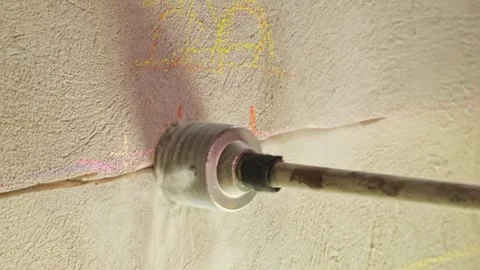 Drilling concrete wall Installing an electrical outlet apartment Round nozzle Stock Footage 264568251