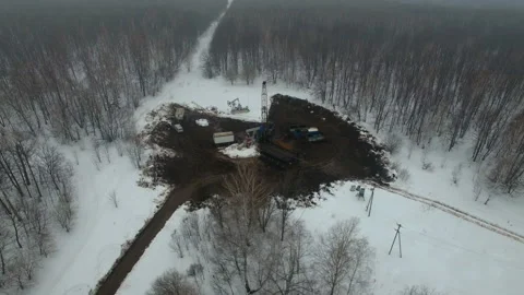 Drilling a deep well with a drilling rig in an oil and gas field in winter Stock Footage 105570610