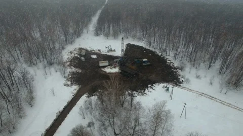 Drilling a deep well with a drilling rig in an oil and gas field in winter Stock Footage 105572803