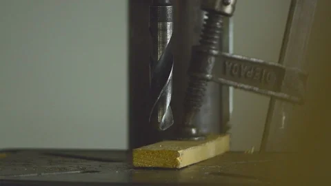 Drilling with a drillpress with big drill bit on wood Close up. Video stock 92774161