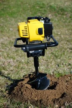 Drilling the ground with rig machine. The man drills the hole in land. Bore.. Stock Photos