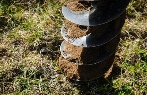 Drilling the ground with rig machine. The man drills the hole in land. Bore.. Stock Photos