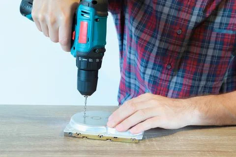 Drilling a Hard Disk Drive to Destroy Evidence Data close up.Cropped image of Stock Photos
