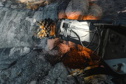 Drilling head of a mine roadheader. Underground mining of ore deposits Stock Photos