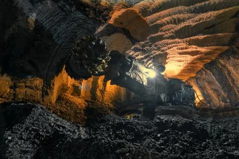 Drilling head of a mine roadheader. Underground mining of ore deposits Stock Photos