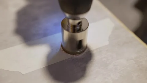 Drilling hole into ceramic tile using core bit Stock Footage 329351611