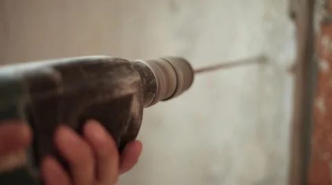 Drilling a hole in a concrete wall with a drill Stock Footage 61695287