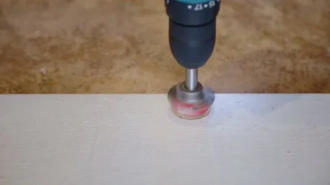 Drilling a hole with a forstner drill for a hinge on a furniture door Stock Footage 165990230