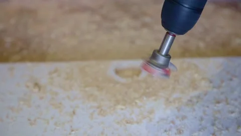 Drilling a hole with a forstner drill for a hinge on a furniture door Stock Footage 166208110