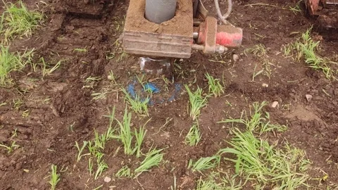 Drilling a hole in the ground close up Stock Footage 246655406