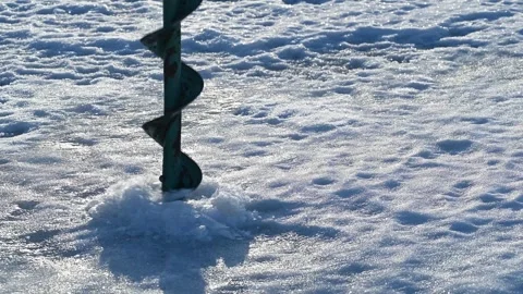 Drilling the hole into ice. Stock Footage 246115485
