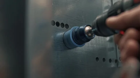 Drilling a hole in a metal wall using a drill with a hammer bit. Stock Footage 265509701