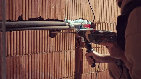Drilling a Hole with a perforator on the Wall for Construction or Renovation Stock Footage 234446234