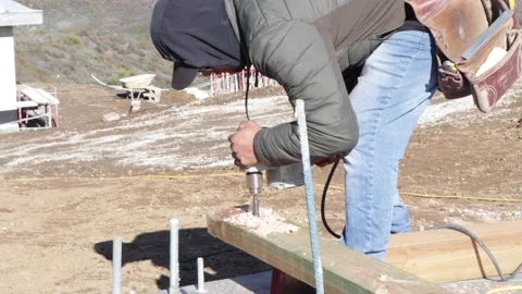 Drilling a hole to a plank at a construction site Stock-Footage 228794795