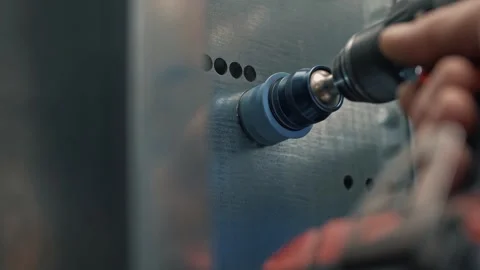 Drilling a hole in sheet metal using a cordless drill with a hammer bit. Stock Footage 265509697