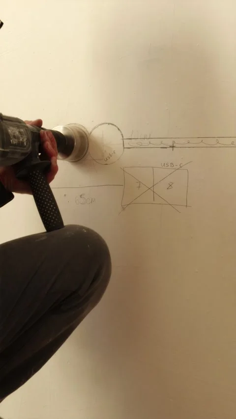 Drilling hole for socket outlet with core drill bit vertical Stock Footage 339298285