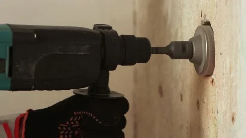 Drilling a hole in the wall for an electrical outlet. 2 Shots. Video stock 219943566