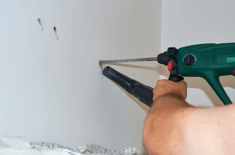 Drilling a hole in a wall Stock Photos