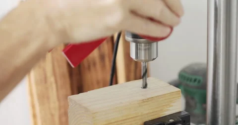 Drilling hole in woodcut using bench  drill press Stock Footage 155032081