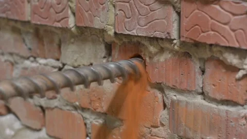 Drilling Holes In A Brick Wall Perfor Stock Pond5 - How To Drill A Hole In The Brick Wall