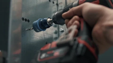 Drilling large diameter holes using a screwdriver with a special toothed bit Stock Footage 265509700