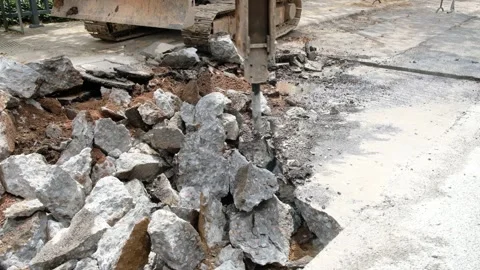 A drilling machine breaks up the concrete floor video with sound Stock Footage 253997355