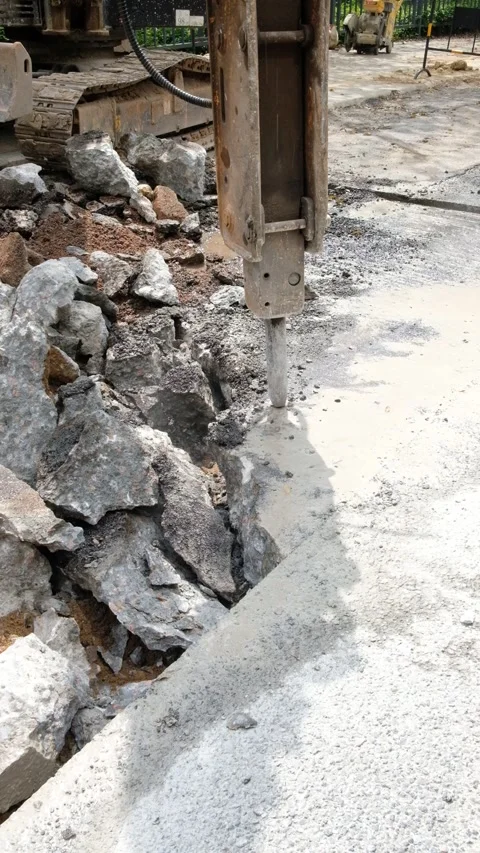A drilling machine breaks up the concrete floor at vertical composition Stock Footage 254174917