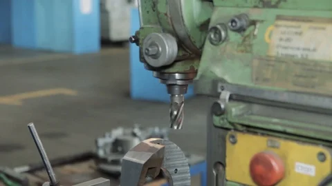 Drilling machine. Drilling holes in the metal plate. Drilling a thick metal pipe Stock Footage 111368356