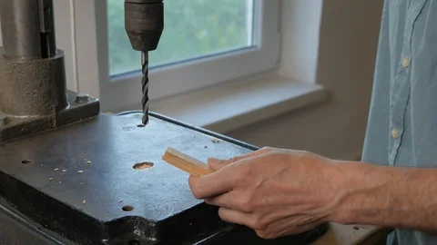 Drilling on the machine. Drilling wood. A man works behind a drilling machine. Stock Footage 109302872