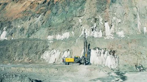 Drilling machine in the middle of an open-pit mine Photos