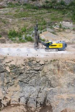 Drilling machine in open cast mining quarry Stock Photos