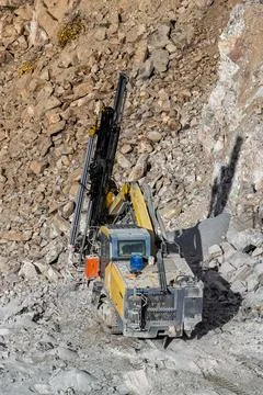 Drilling machine in open cast mining quarry Stock Photos
