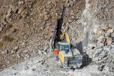 Drilling machine in open cast mining quarry Stock Photos