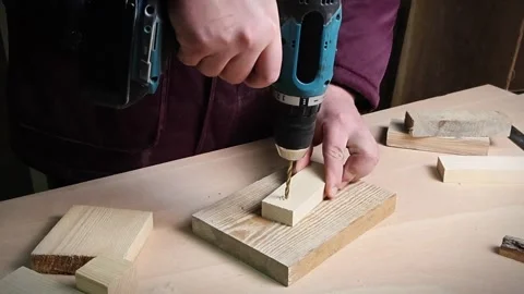 Drilling machine working on a piece of wood material Stock Footage 294926226