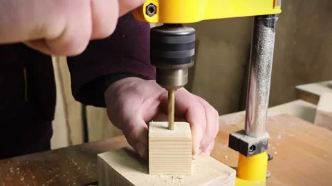 Drilling machine working on a piece of wood material in workshop Stock Footage 294926227