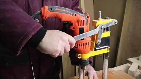 Drilling machine working on a piece of wood material in carpentry workshop Stock Footage 294926300