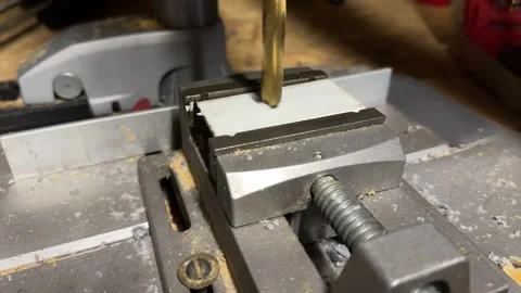Drilling metal profile fixed in vise on workbench Stock Footage 326968929