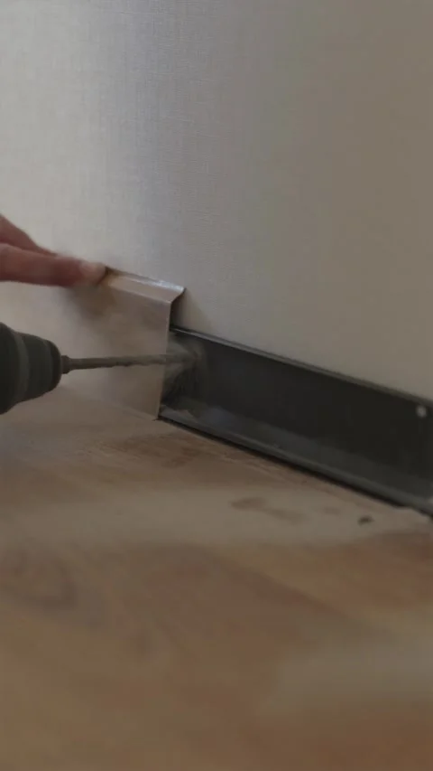 Drilling mounting hole in wall with cordless screwdriver tool Stock Footage 346396685