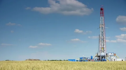 Drilling an oil well in a wheat field Stock Footage