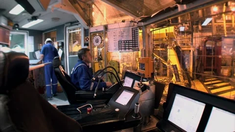 Drilling operator monitors controls inside offshore oil rig control room Stock-Footage 331504693